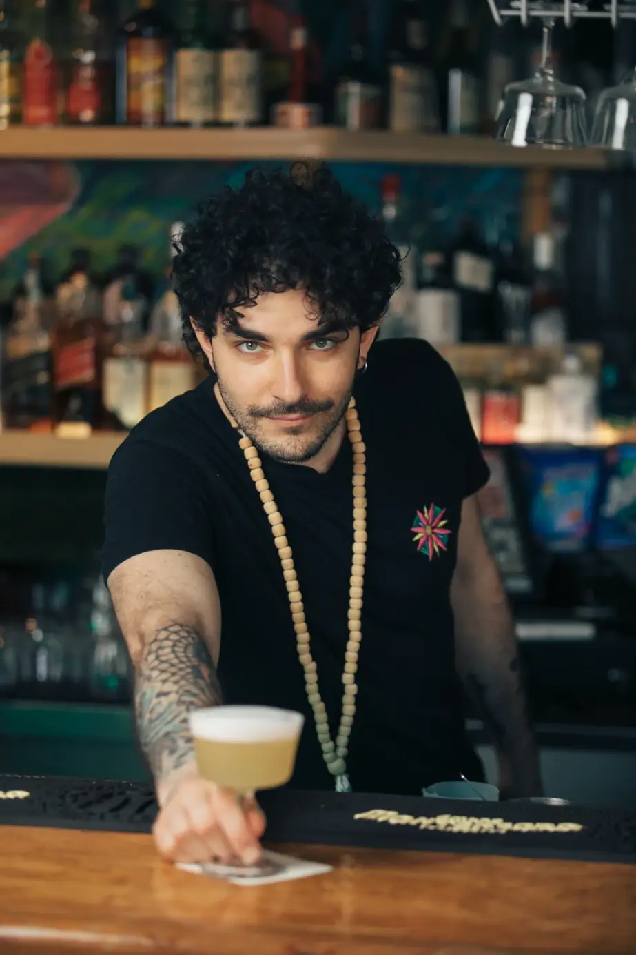 Barman che serve un cocktail al bancone